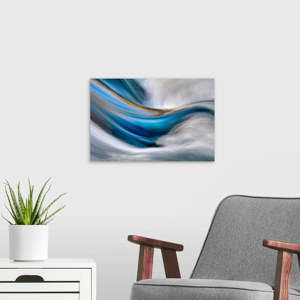 A modern room featuring Abstract painting in which cool and warm tones flow from left to right while white rushes from th...