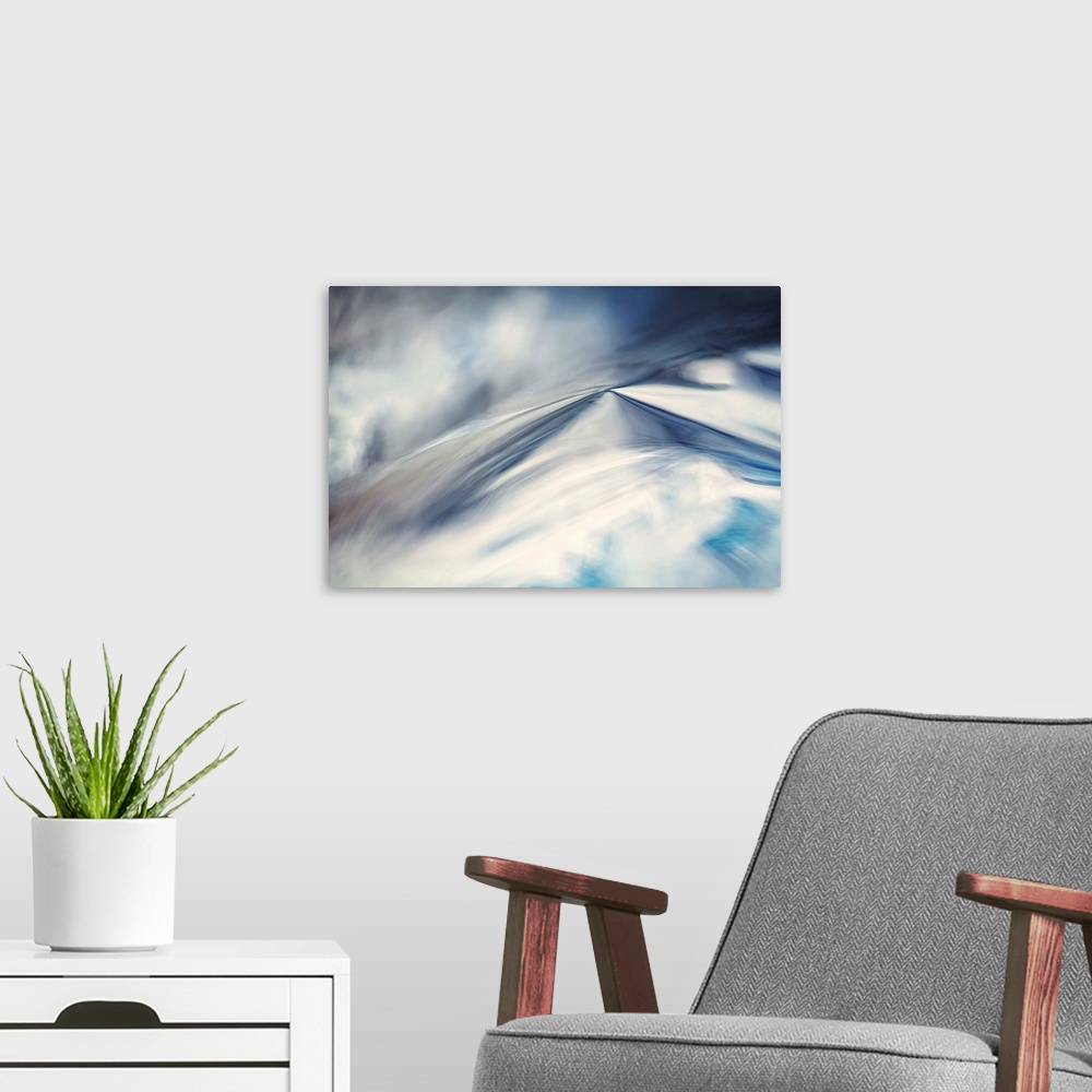 A modern room featuring Abstract artwork of blues and whites to create an illusion of snow.