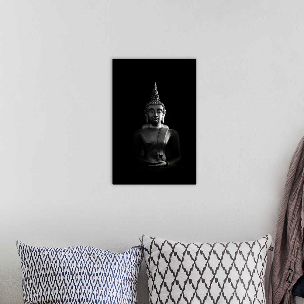 A bohemian room featuring Buddha bust in black and white