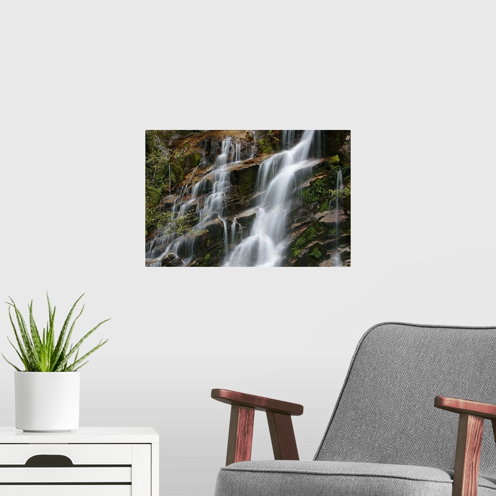 A modern room featuring Giant horizontal photograph of small streams of water falling and flowing over a steeply sloped r...