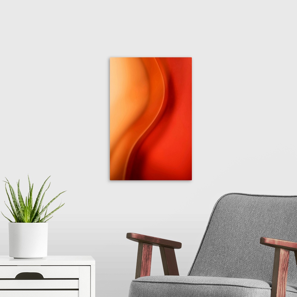 A modern room featuring Abstract artwork that uses warm colors throughout with a single wave down the middle.