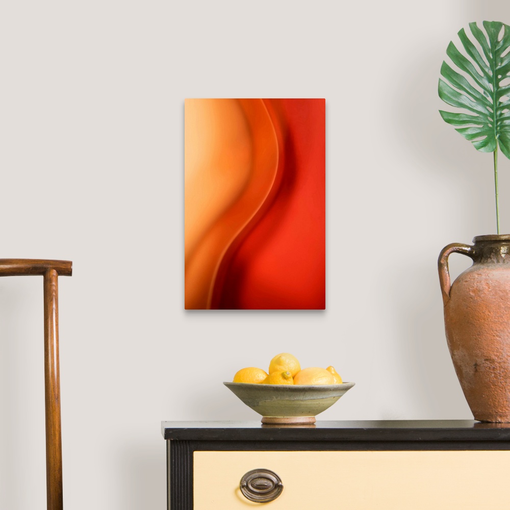 A traditional room featuring Abstract artwork that uses warm colors throughout with a single wave down the middle.