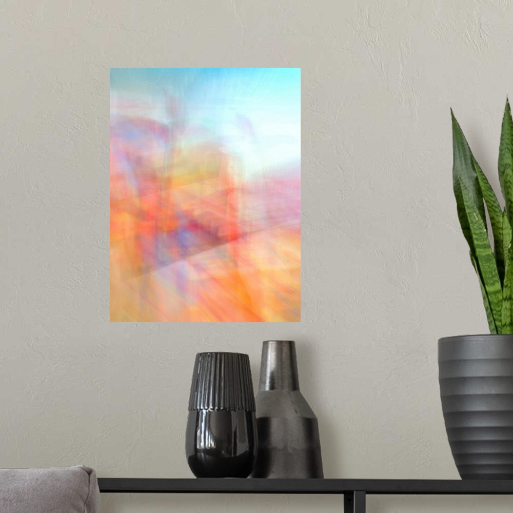 A modern room featuring An abstract image full of energy and movement in oranges, pinks, turquoise, blues, yellows and reds.