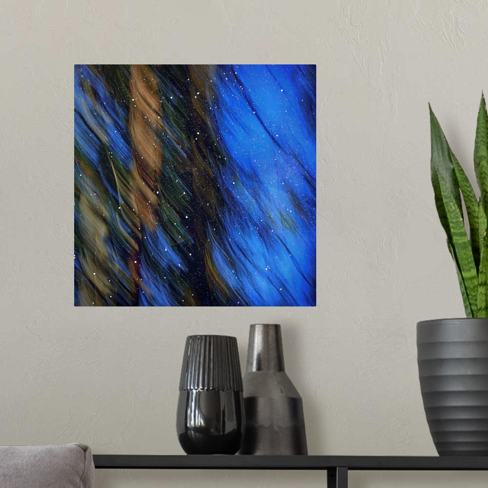 A modern room featuring Abstract image of pine trees on a bright blue sky with wispy lines from motion blur and white sta...
