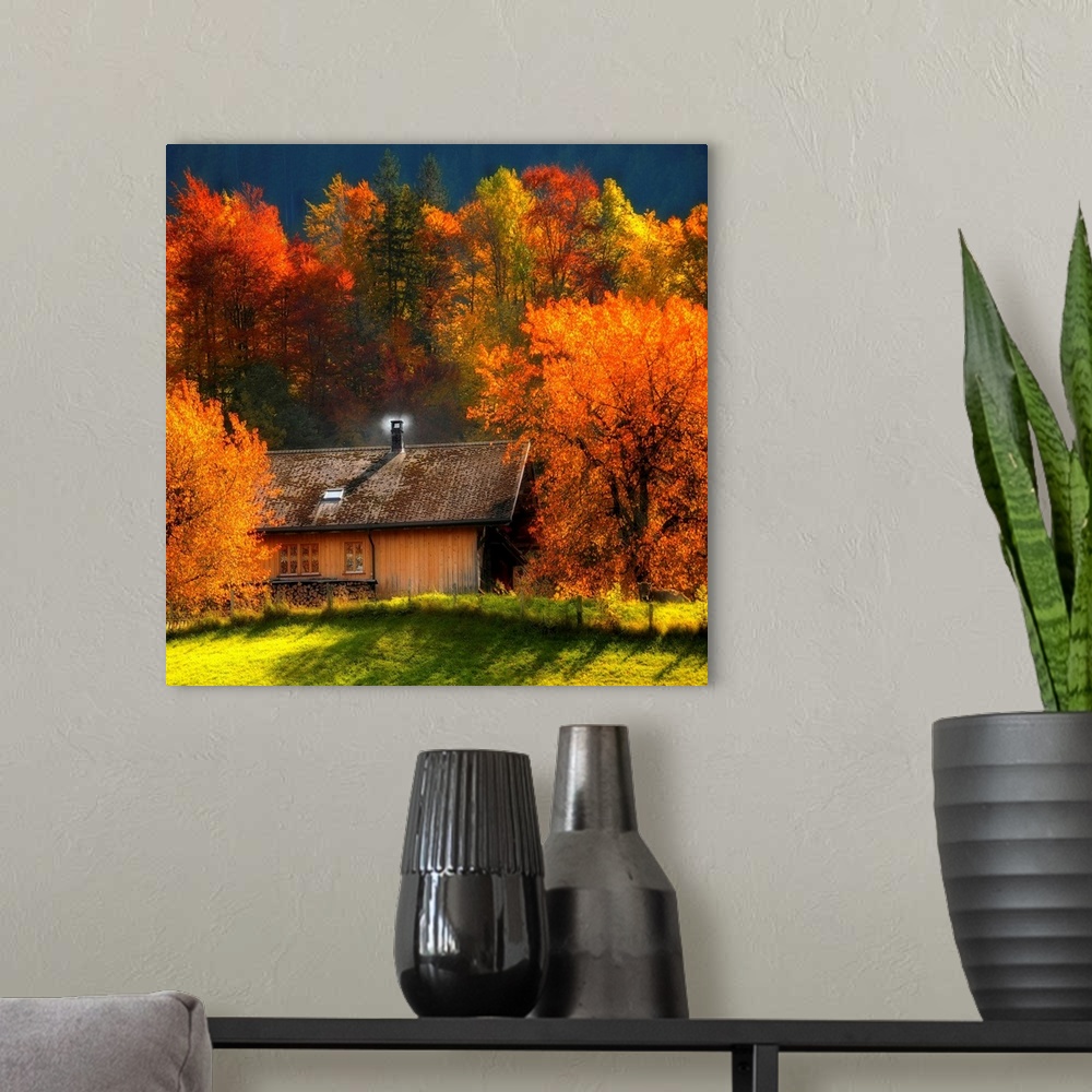 A modern room featuring Big artwork of a cabin with a smoking chimney in the woods in autumn as the leaves turn to their ...