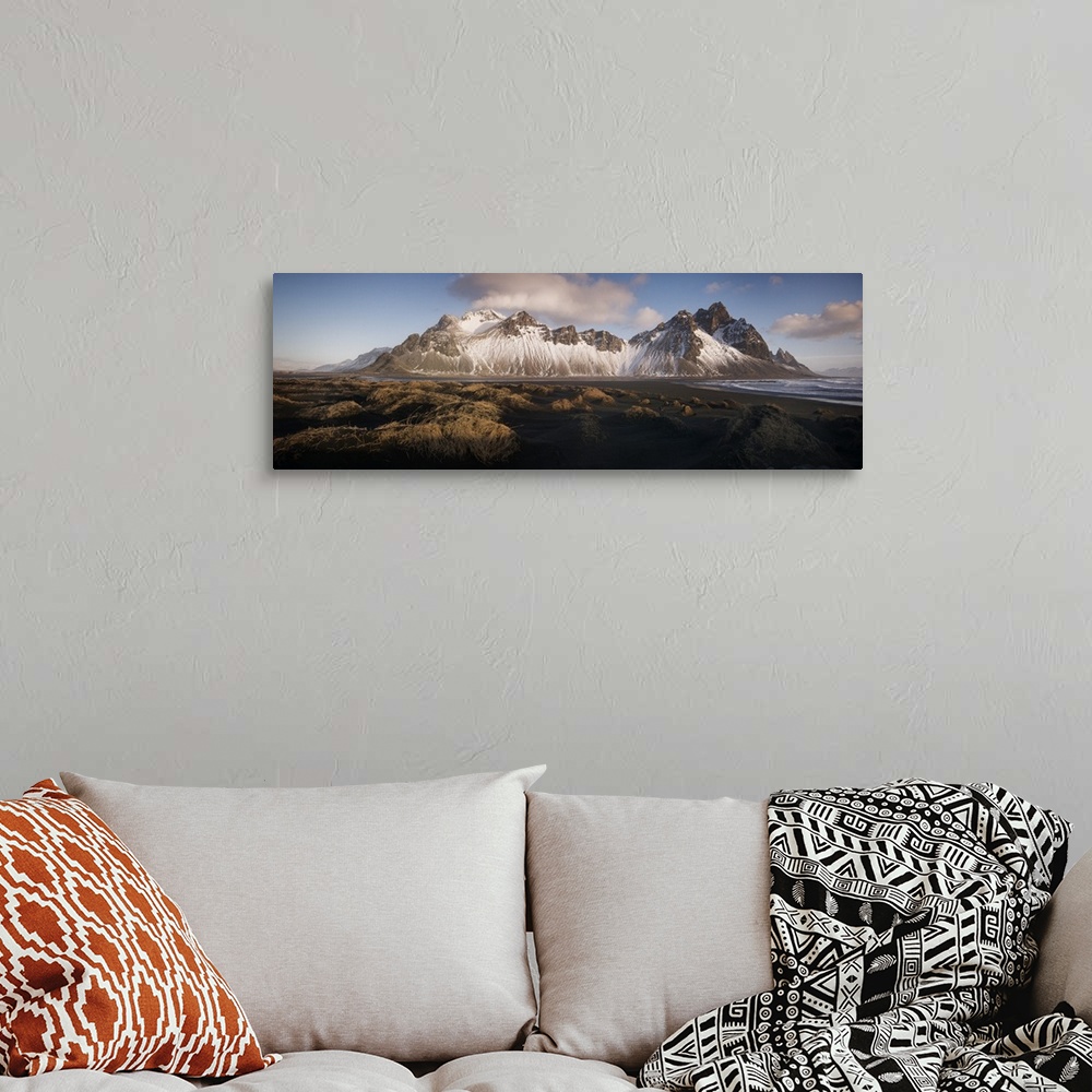 A bohemian room featuring Panoramic view of Vestrahorn mountain covered in snow, seen from the black sand beach, Stokksnes,...