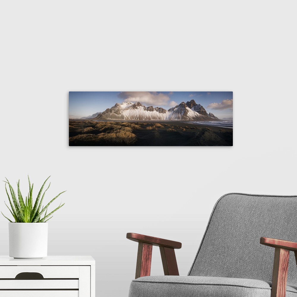A modern room featuring Panoramic view of Vestrahorn mountain covered in snow, seen from the black sand beach, Stokksnes,...