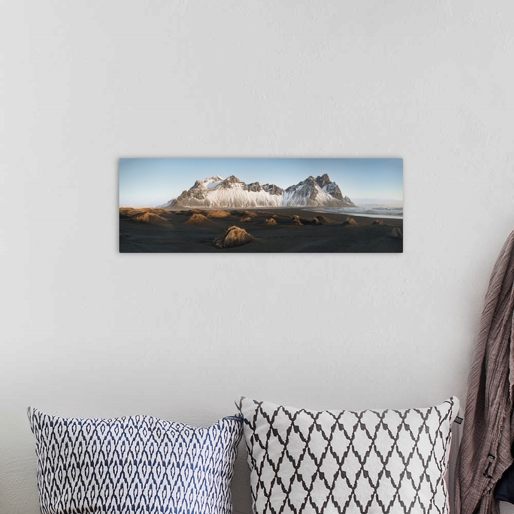 A bohemian room featuring Panoramic view of Vestrahorn mountain covered in snow, seen from the black sand beach, Stokksnes,...
