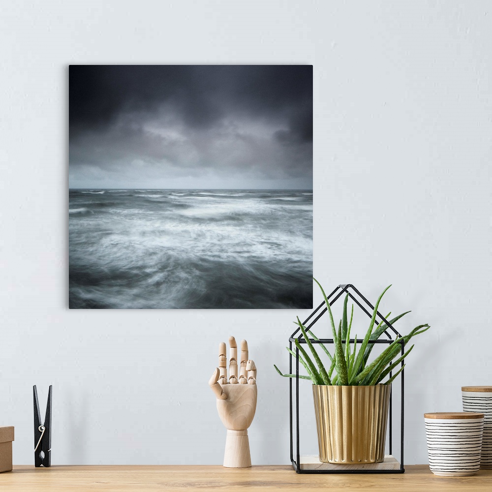A bohemian room featuring A stormy seascape, minimalist with swirling waves and a stormy sky in greys, greens, blues and si...