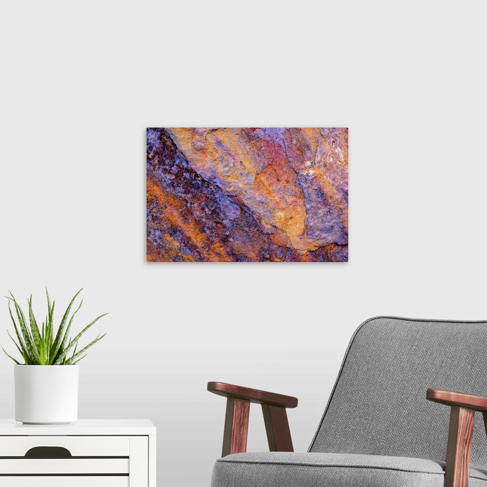 A modern room featuring A close-up photograph of a multi-colored rock in purple and orange.