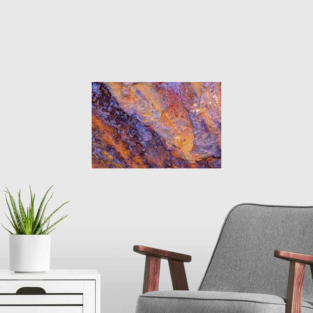 A modern room featuring A close-up photograph of a multi-colored rock in purple and orange.