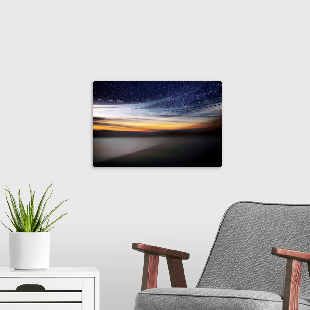 A modern room featuring Fine art photo of a starry night sky over the light of the setting sun from the coast.