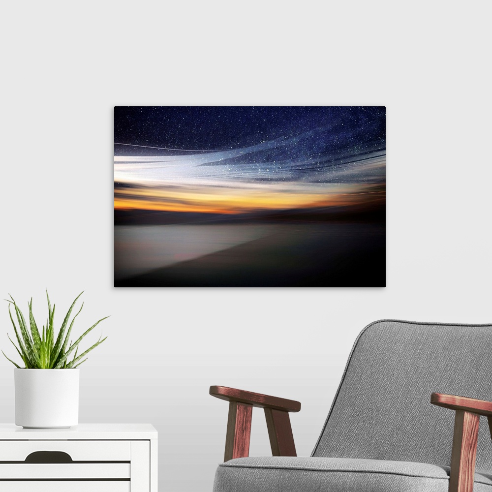 A modern room featuring Fine art photo of a starry night sky over the light of the setting sun from the coast.