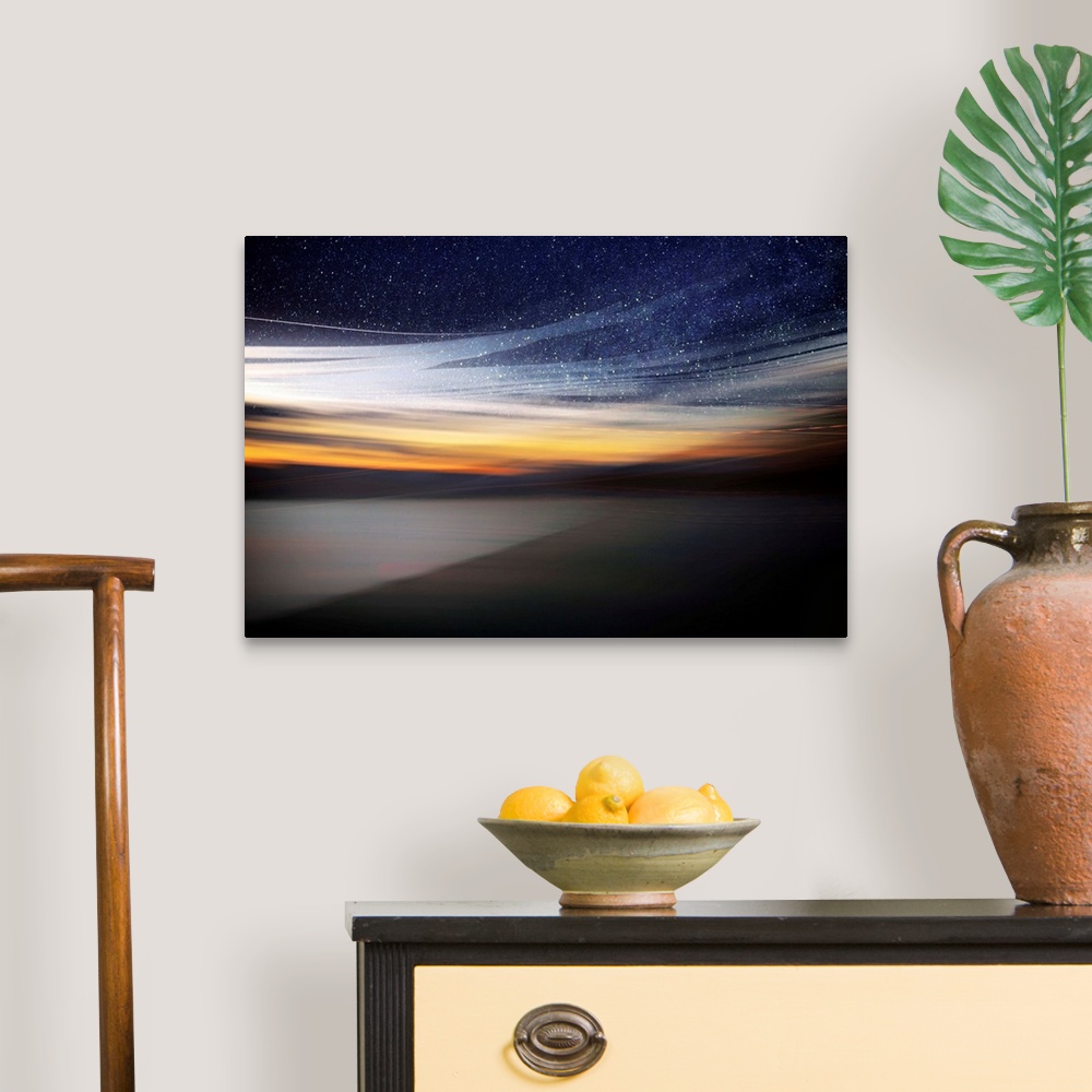 A traditional room featuring Fine art photo of a starry night sky over the light of the setting sun from the coast.