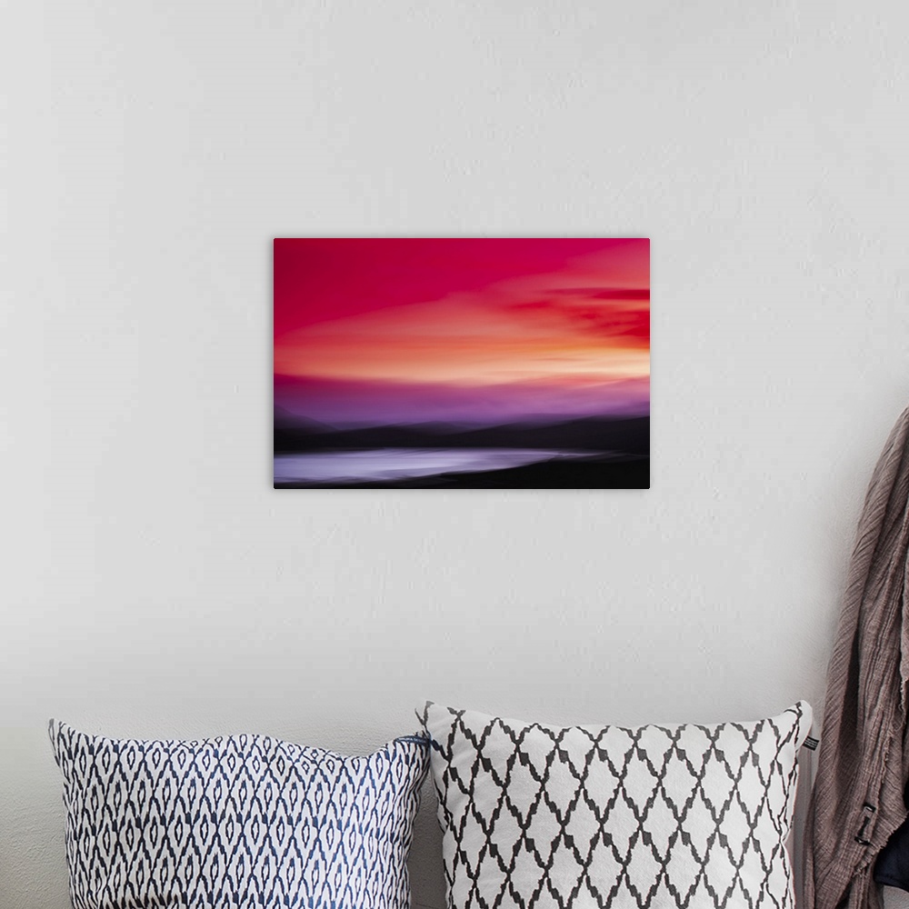 A bohemian room featuring Abstract landscape sunset with red and pink skies over black mountains and a lake.