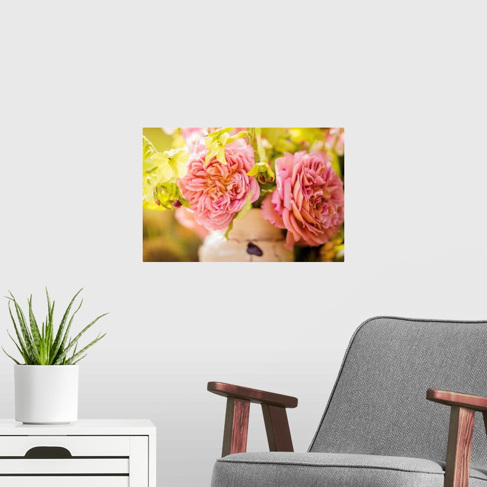 A modern room featuring Close-up photograph of pink English roses in an arrangement with a shallow depth of field.