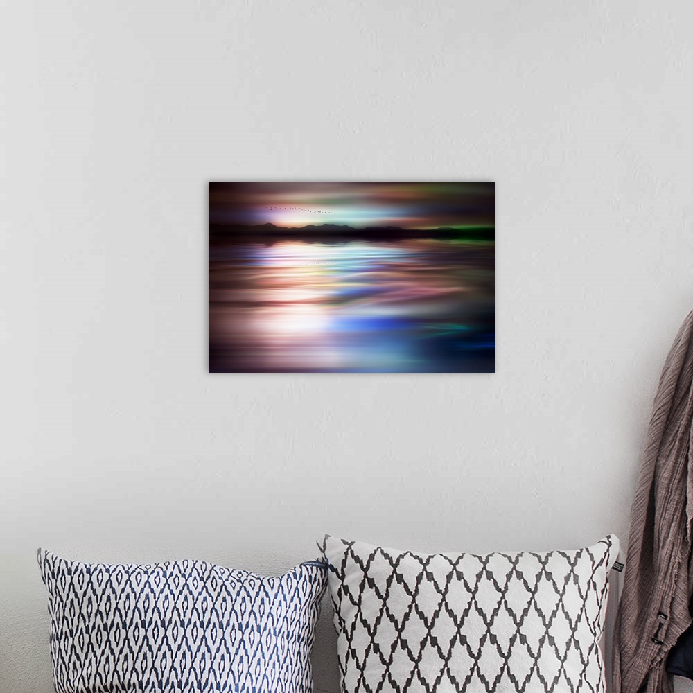 A bohemian room featuring Abstract photograph of a flock of birds flying above a dreamy, wavy body of water with a mountain...
