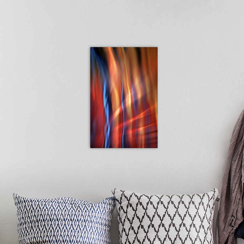 A bohemian room featuring Abstract photograph of blurred and blended colors and flowing lines, with blue and orange waves.