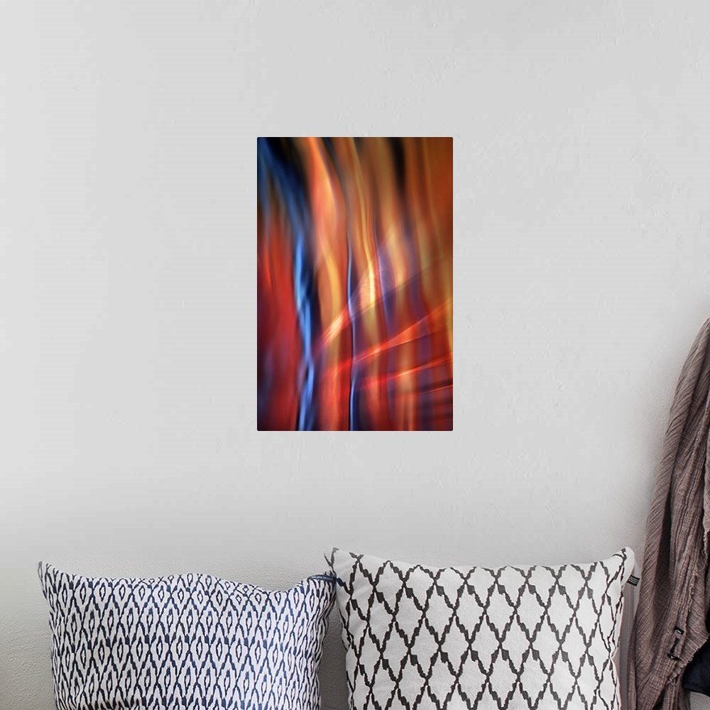 A bohemian room featuring Abstract photograph of blurred and blended colors and flowing lines, with blue and orange waves.