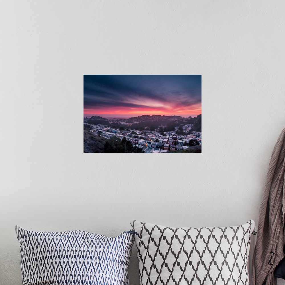 A bohemian room featuring Dramatic pink and orange clouds over Twin Peaks in San Francisco during sunset.