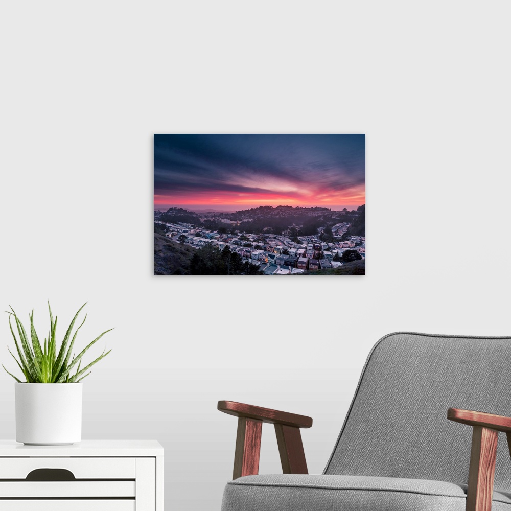 A modern room featuring Dramatic pink and orange clouds over Twin Peaks in San Francisco during sunset.
