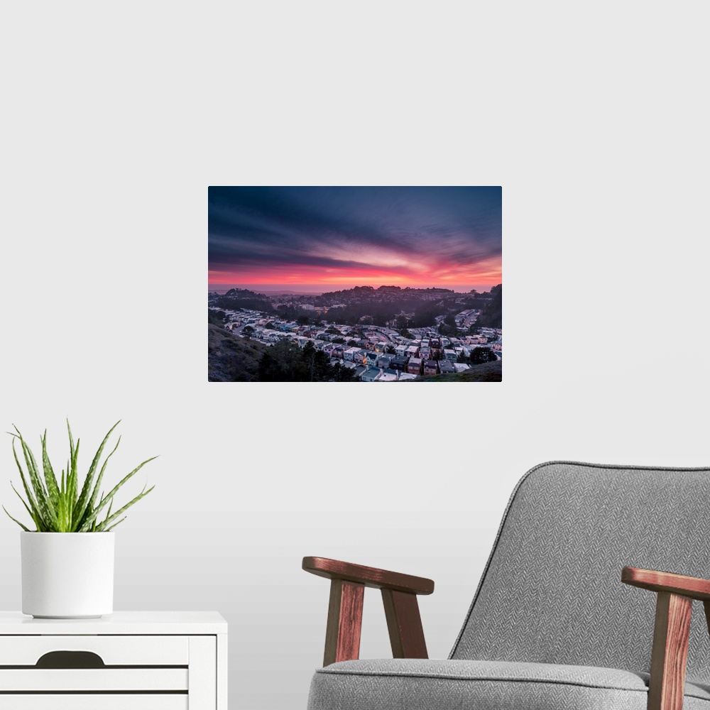 A modern room featuring Dramatic pink and orange clouds over Twin Peaks in San Francisco during sunset.