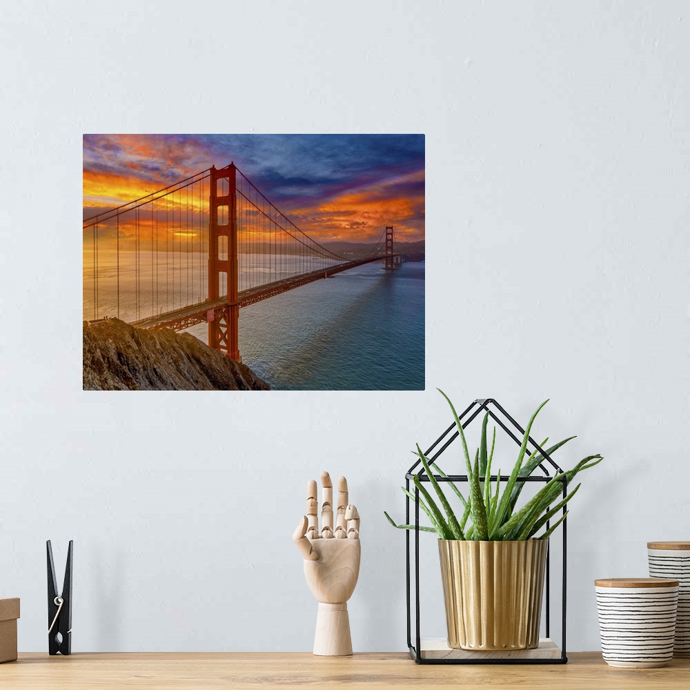 A bohemian room featuring An iconic image of the beautiful San Francisco bridge and the colors of the sunset.