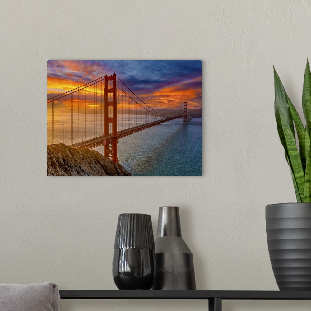 A modern room featuring An iconic image of the beautiful San Francisco bridge and the colors of the sunset.