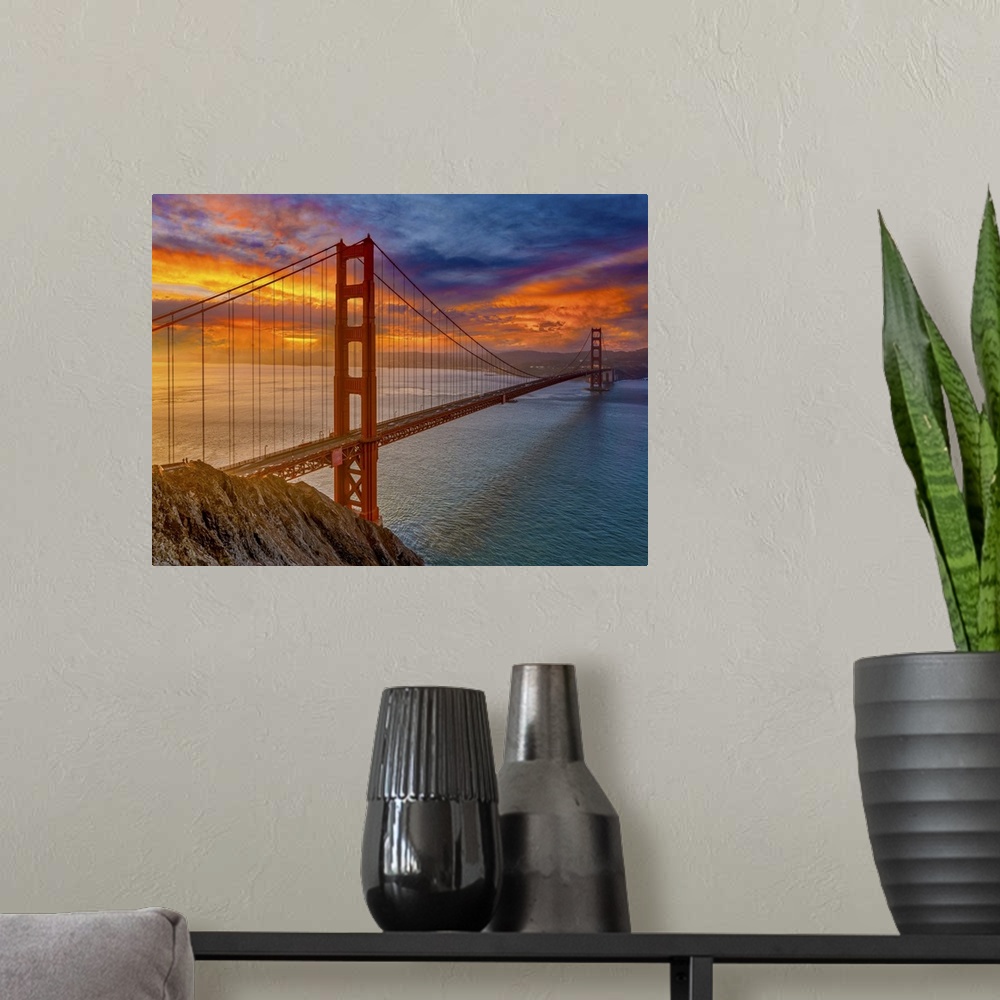 A modern room featuring An iconic image of the beautiful San Francisco bridge and the colors of the sunset.
