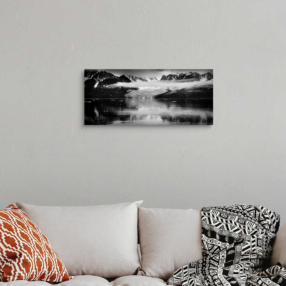 A bohemian room featuring Black and white photograph of a glacer and mountains in Svalbard, Norway.