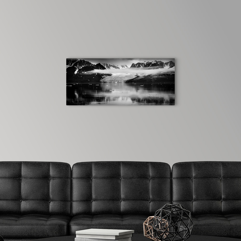 A modern room featuring Black and white photograph of a glacer and mountains in Svalbard, Norway.