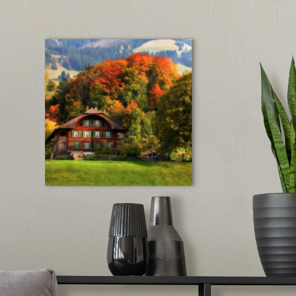 A modern room featuring Photograph of cabin at the bottom of a foothill with autumn colored forest in the background.
