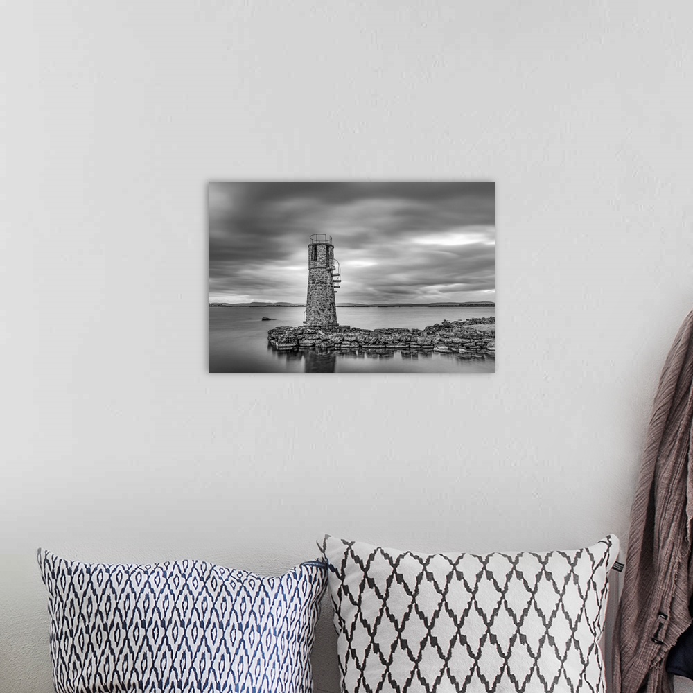 A bohemian room featuring Black and white photo of an old lighthouse by a lake