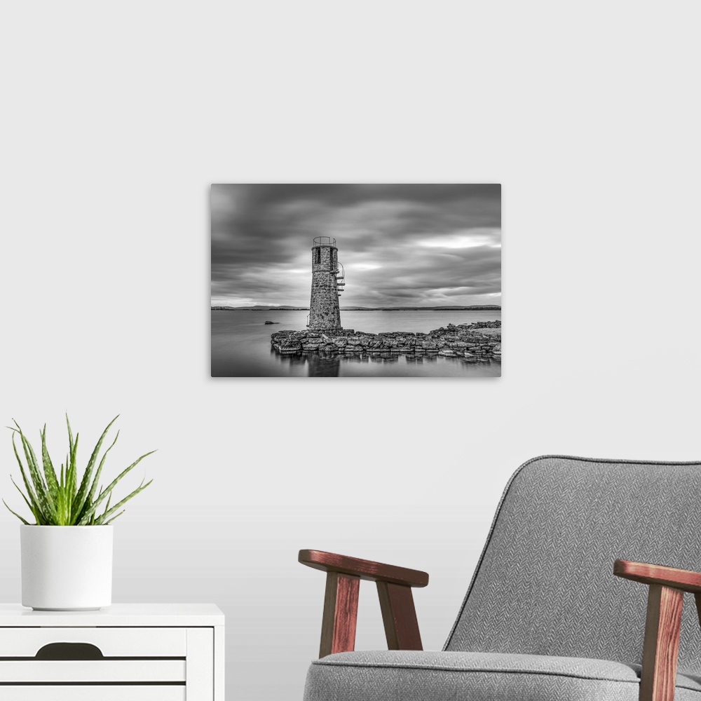 A modern room featuring Black and white photo of an old lighthouse by a lake