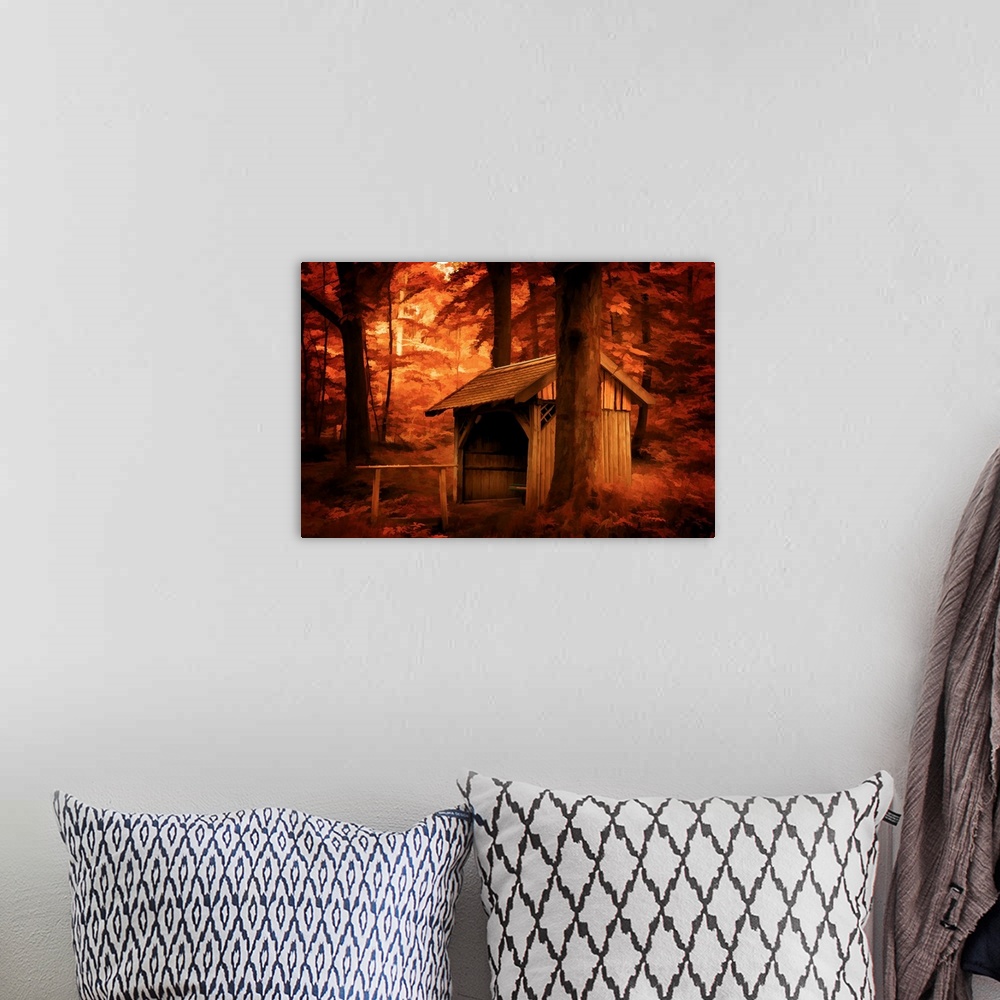 A bohemian room featuring A photograph of a stable surrounded by trees in autumn foliage.