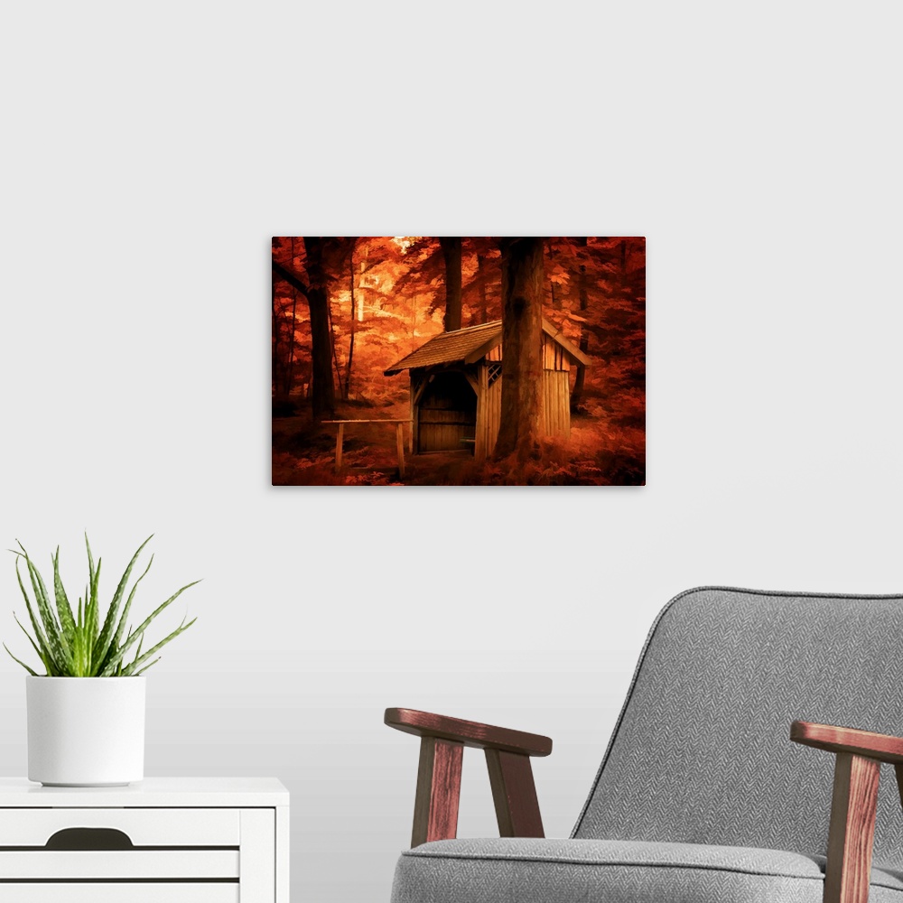 A modern room featuring A photograph of a stable surrounded by trees in autumn foliage.