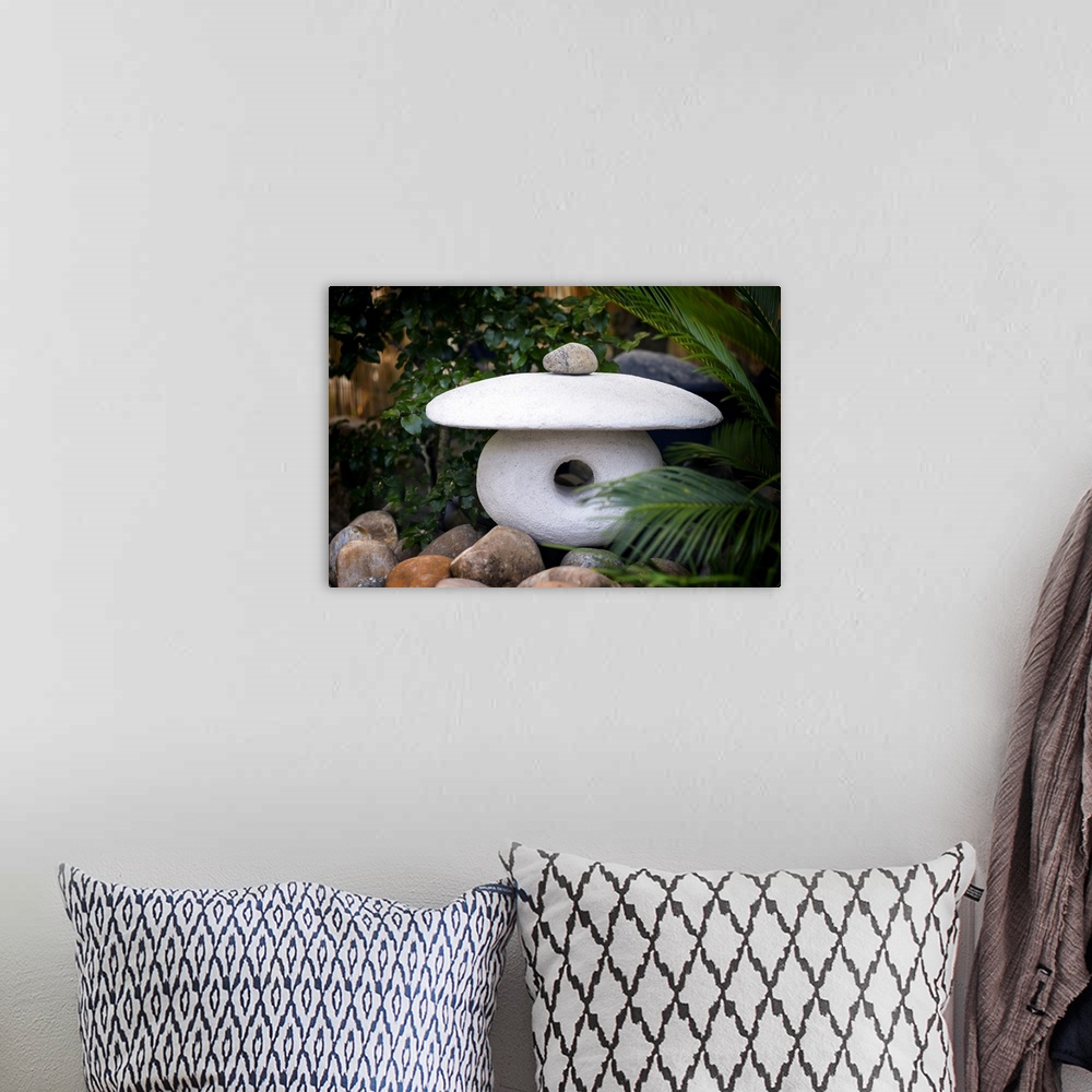 A bohemian room featuring Fine art photo of a zen sculpture made of three carved stones.
