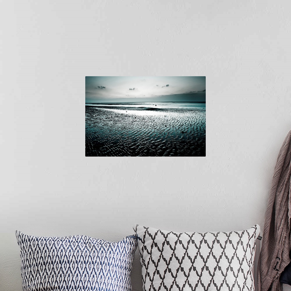 A bohemian room featuring Big, landscape, fine art photograph of a wet, empty beach, surrounded by darkness beneath a gray ...