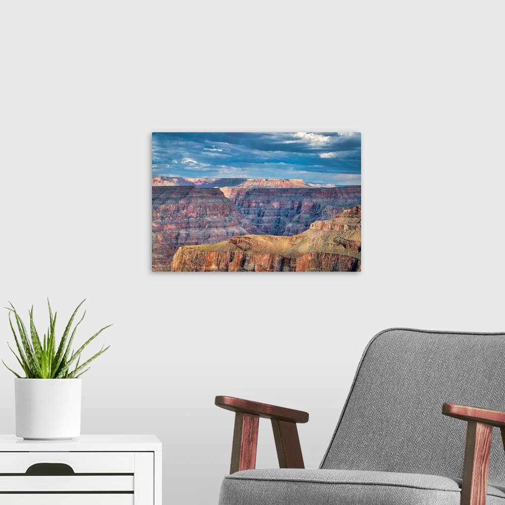 A modern room featuring Photograph of a beautiful canyon landscape with a blue, cloudy sky above.