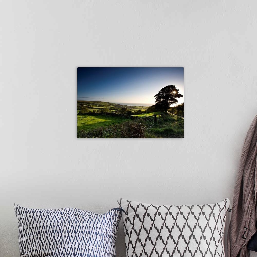 A bohemian room featuring A spring landscape of green fields and trees with a blue sky looking down to the coast in North Y...