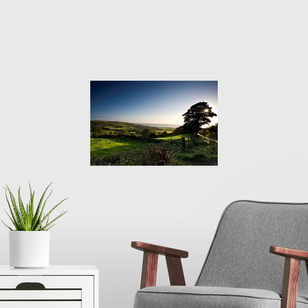 A modern room featuring A spring landscape of green fields and trees with a blue sky looking down to the coast in North Y...