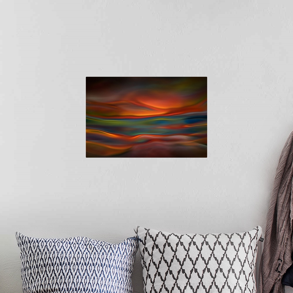 A bohemian room featuring Abstract photograph of blurred and blended colors and flowing lines in shades of orange and blue.
