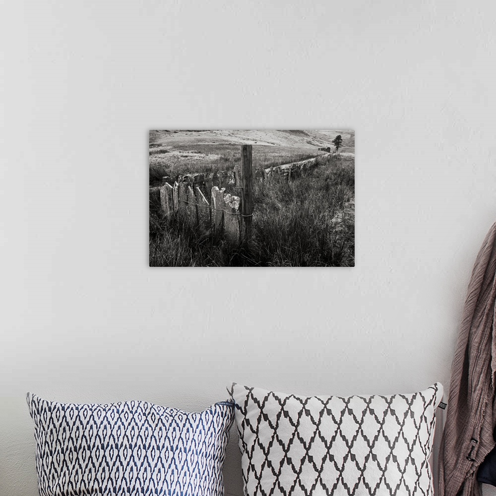 A bohemian room featuring A black and white photograph of a countryside landscape.
