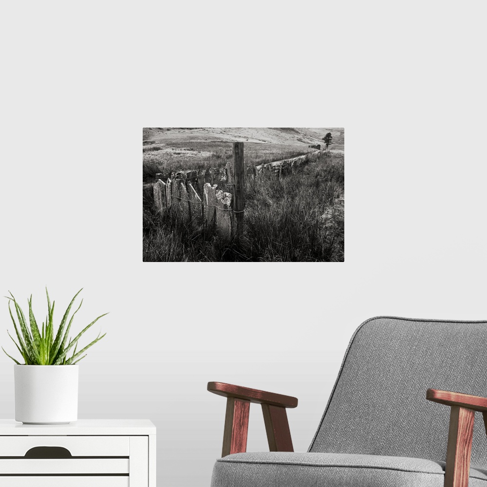 A modern room featuring A black and white photograph of a countryside landscape.