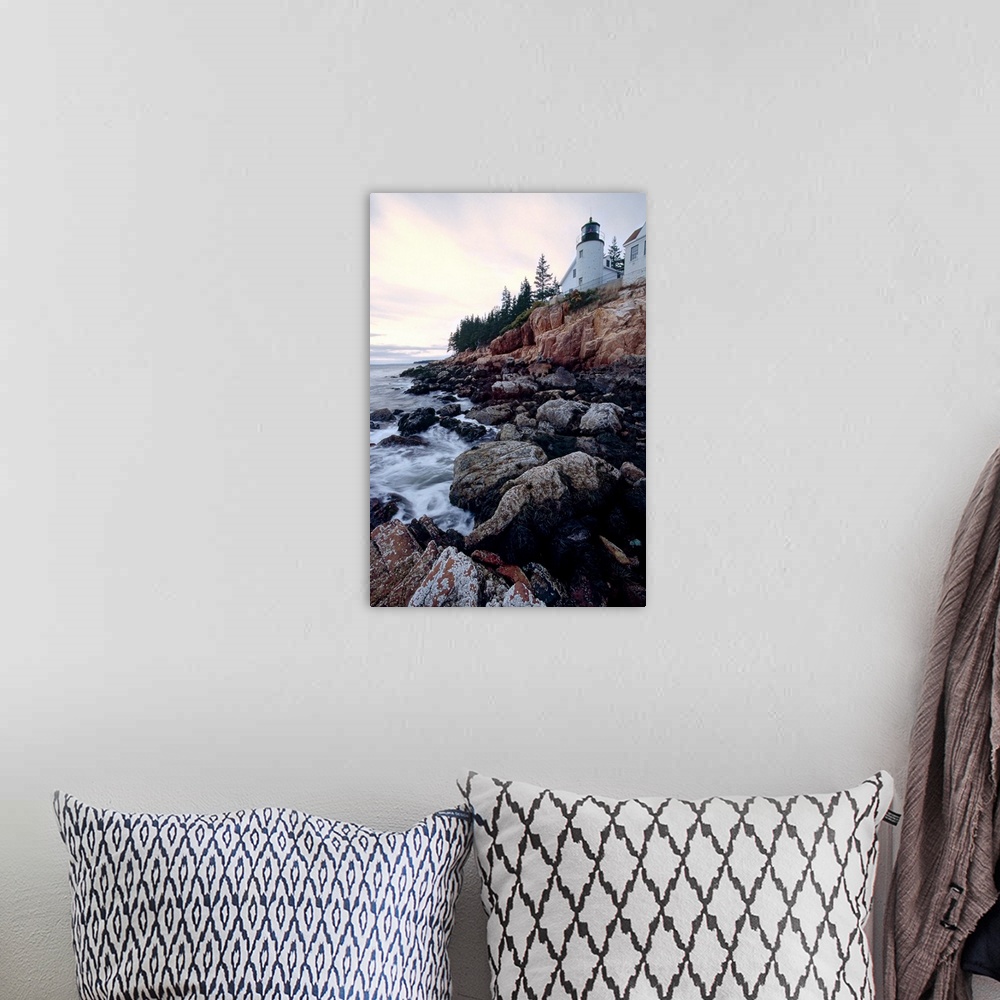 A bohemian room featuring Low angle view of the bass harbor head lighthouse that sits atop a rocky cliff.