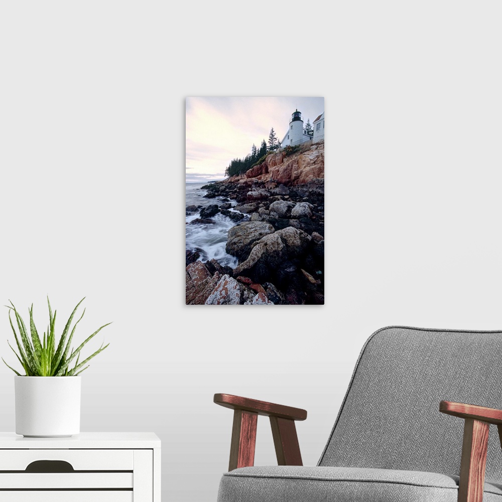 A modern room featuring Low angle view of the bass harbor head lighthouse that sits atop a rocky cliff.