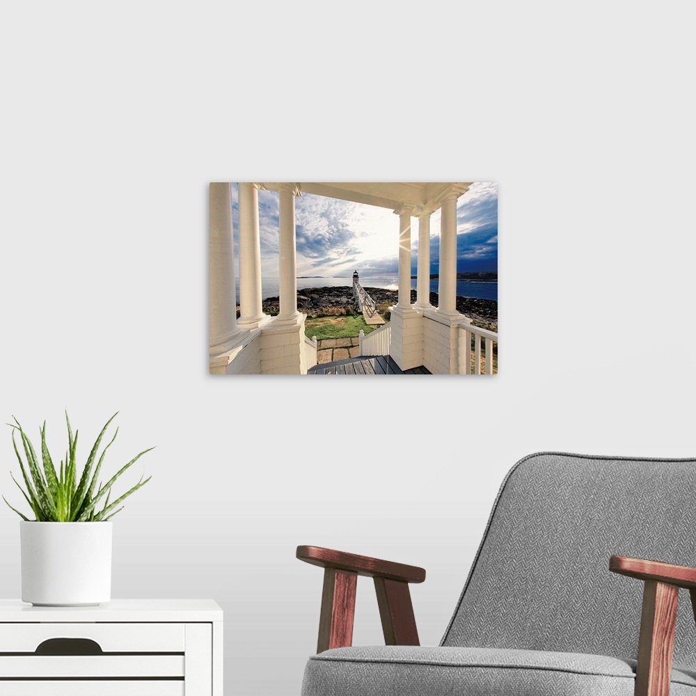 A modern room featuring Huge photograph taken from a covered shelter with numerous columns in front of a house overlookin...