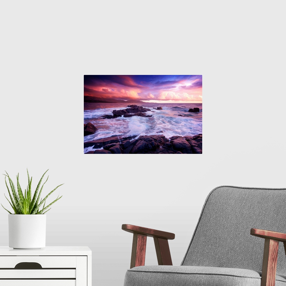 A modern room featuring A photograph of a rocky sunset coastal landscape.