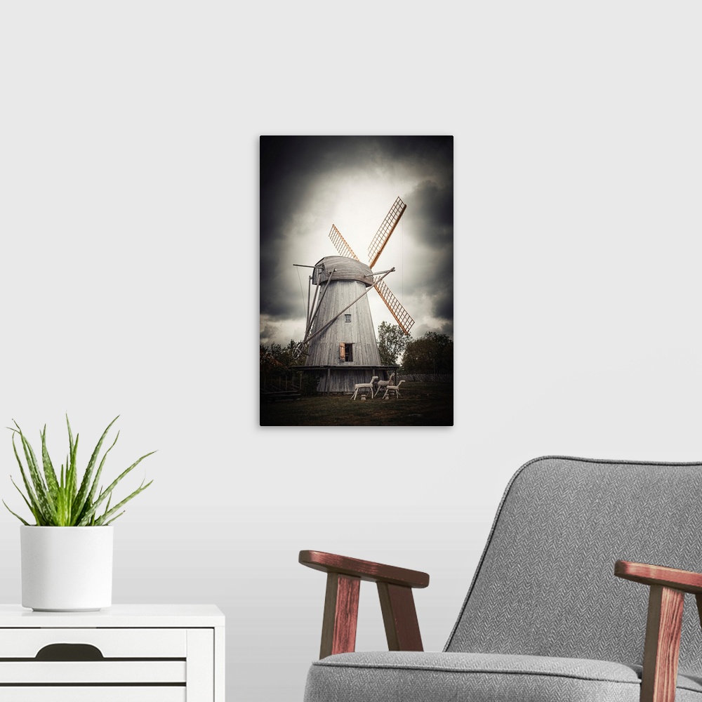 A modern room featuring Old windmill close up with stormy sky