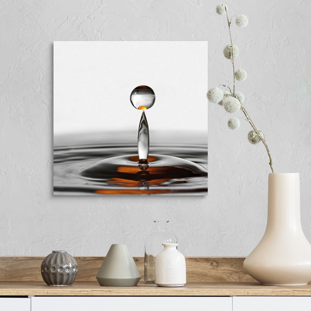 A farmhouse room featuring A photograph of a water droplet rising up from a splash.
